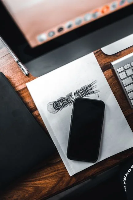 High-angle view of a stylish work desk featuring dual monitors, keyboard, mouse, and modern accessories.
